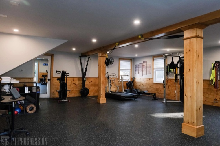 Strength and conditioning equipment along the wood-panelled wall